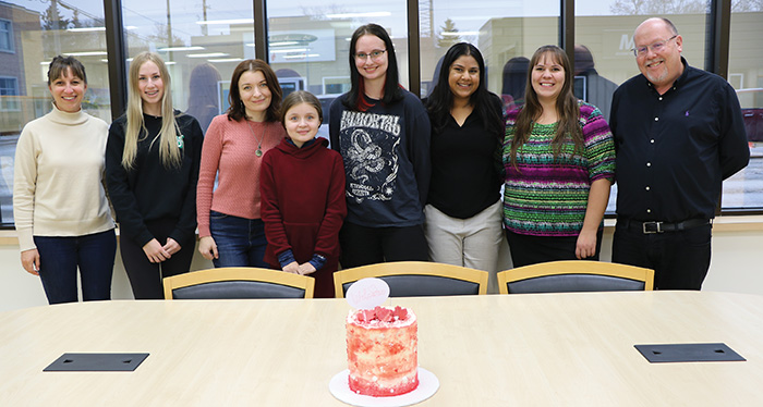 The World-Spectator’s newest employee, Olha Volokh, is a recent arrival from Ukraine. From left on her first day of work are Kara Kinna, Ashley Bochek, Olha and her daughter Zlata, Ella Ferguson, Sierra D’Souza Butts, Felicité Mailloux, and Kevin Weedmark.<br />